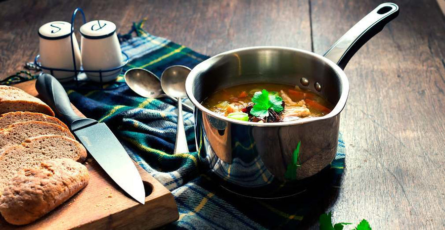 cock a leekie soup in a stainless steel pan with bread