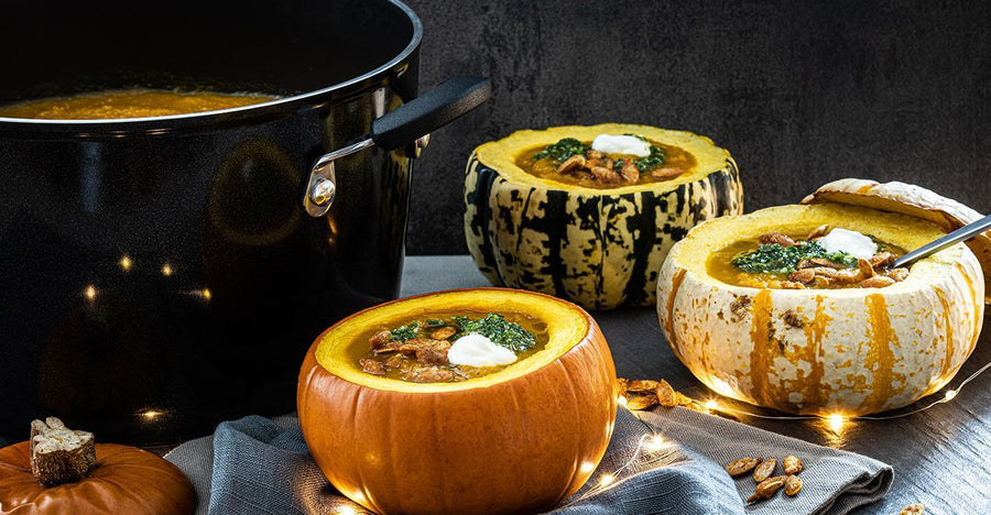 Pumpkin soup in three small pumpkin bowls