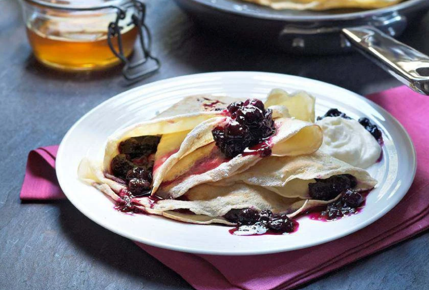 Pancakes with honey and whipped cream for pancake day