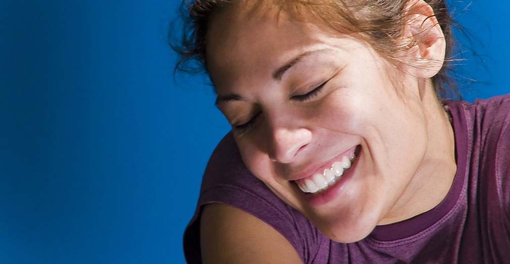 Happy woman smiling against blue background