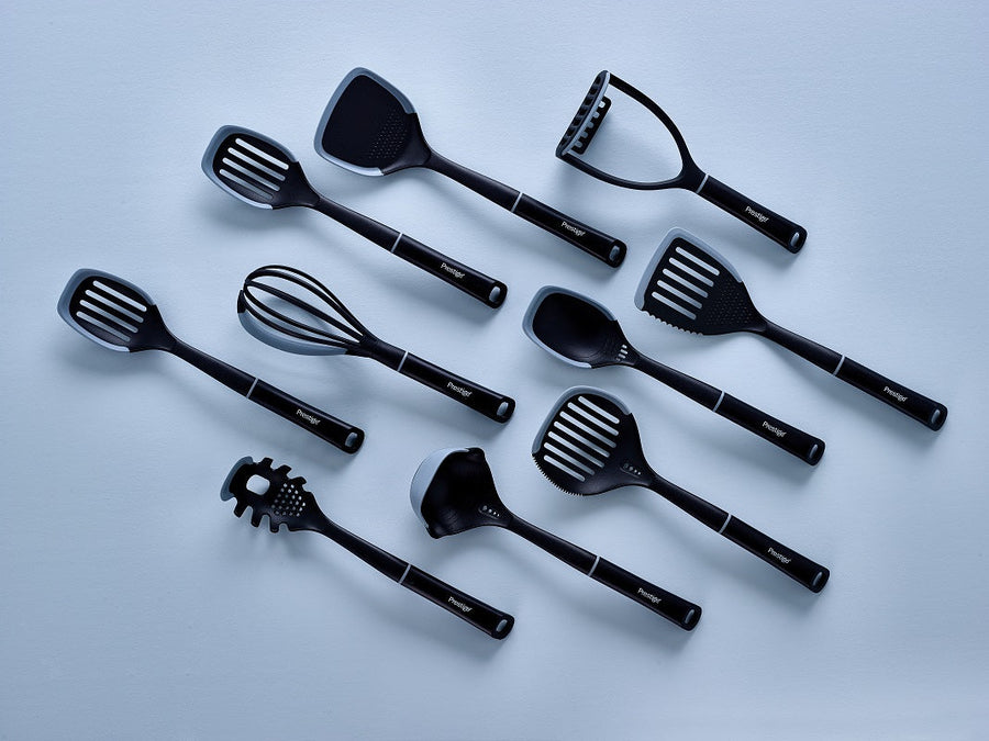 the full range of Prestige kitchen utensils spread out on a blue background